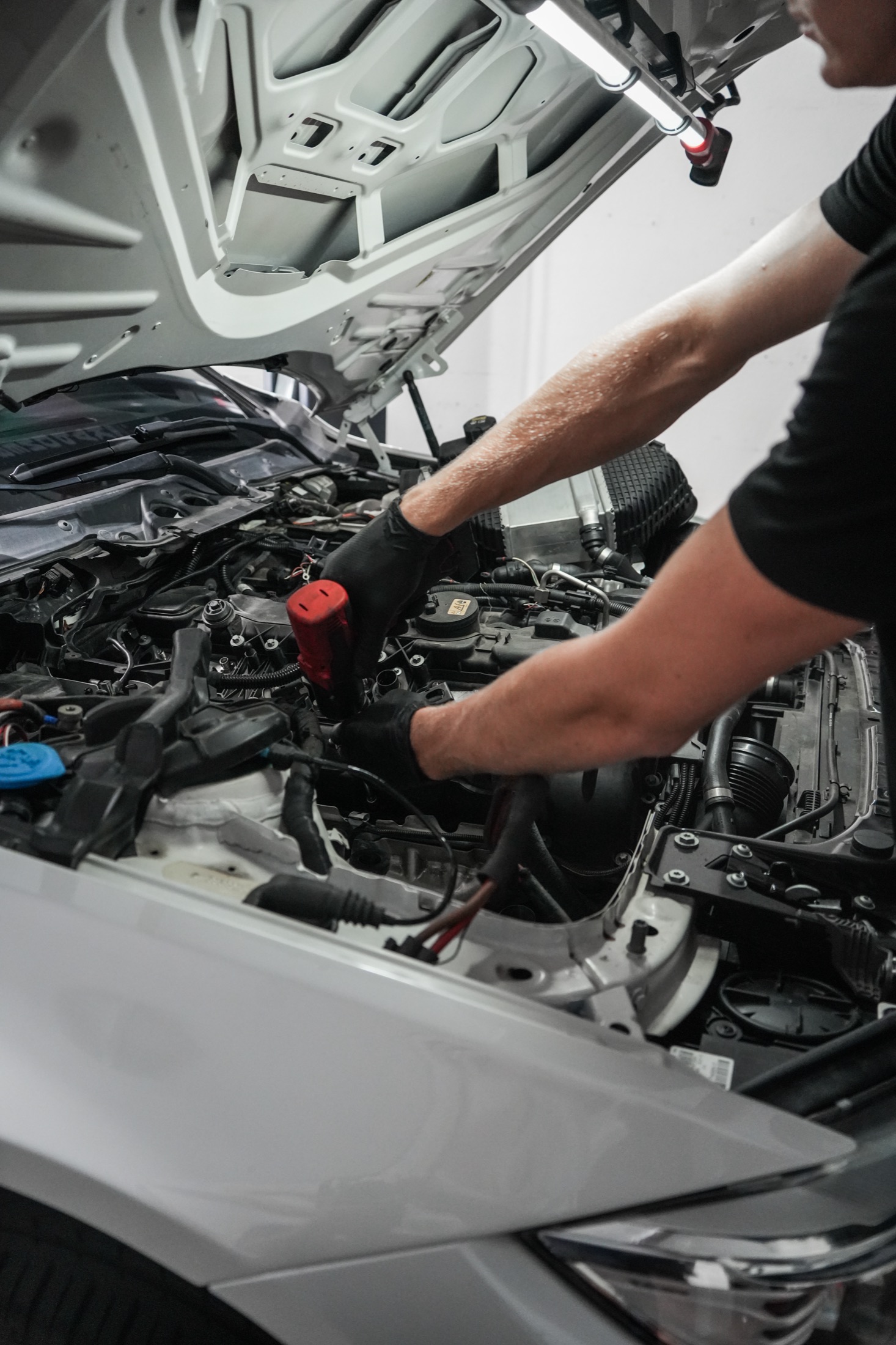 Technician working in an engine bay