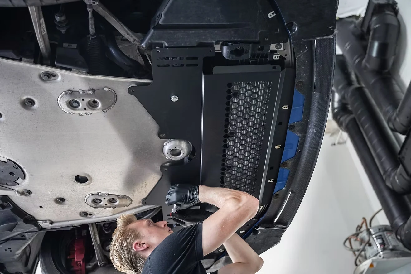 Technician working underneath a car